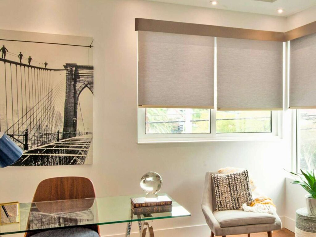 Modern office with roller shades and art
