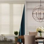 faux wood blinds in a kitchen and wood blinds in a dining room