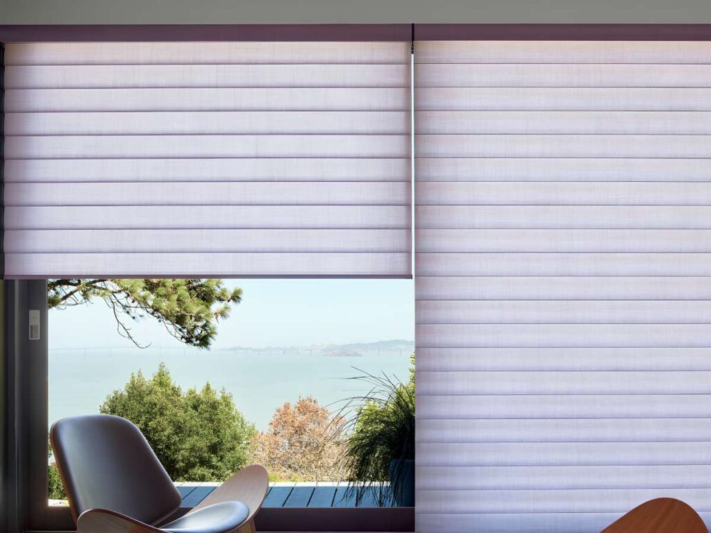 This is a photo of an automated roman shades remote control on the wall