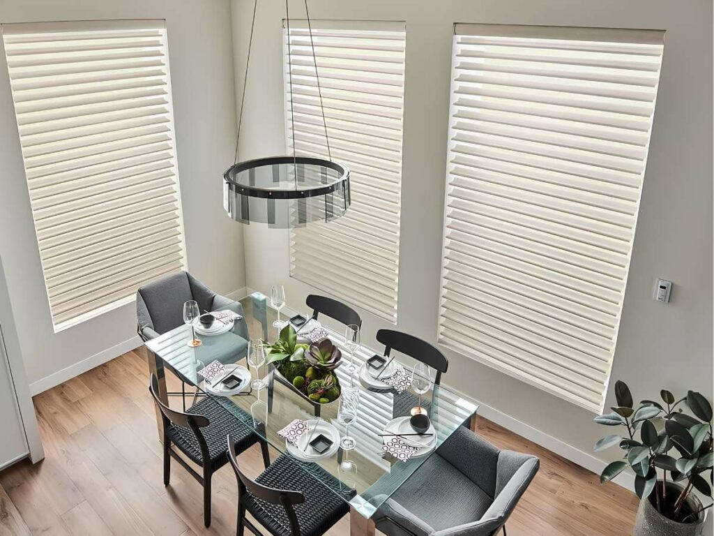 This is a photo of a motorized sheer shades in a large window in a dining room